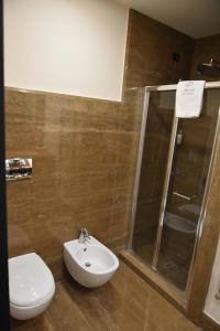 a bathroom with a toilet and a sink and a shower at Alvino Suite And Breakfast in Lecce