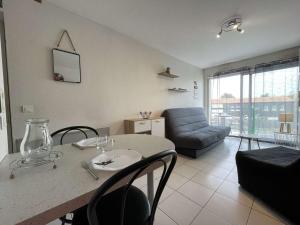 a living room with a table and a couch at Appartement La Rochelle, 1 pièce, 2 personnes - FR-1-246-607 in La Rochelle