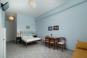 a kitchen with a table and a dining room at Spertos Apartments in Órmos
