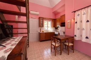 a bedroom with a bunk bed and a kitchen with a table at Spertos Apartments in Órmos