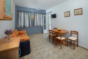 a living room with a couch and a table at Spertos Apartments in Órmos