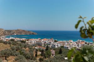a town on a hill next to the ocean at Spertos Apartments in Órmos