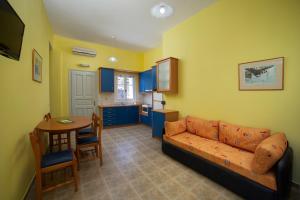 a living room with a couch and a table at Spertos Apartments in Órmos