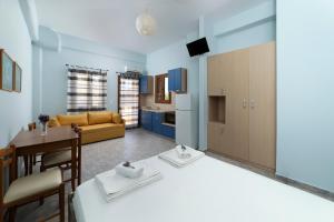 a kitchen and living room with a bed and a table at Spertos Apartments in Órmos