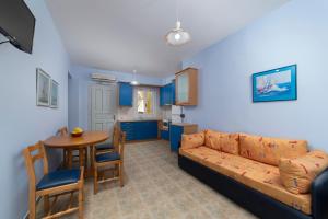 a living room with a couch and a table at Spertos Apartments in Órmos