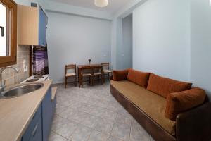 a living room with a couch and a table at Spertos Apartments in Órmos