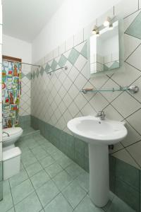 a bathroom with a sink and a toilet at Spertos Apartments in Órmos