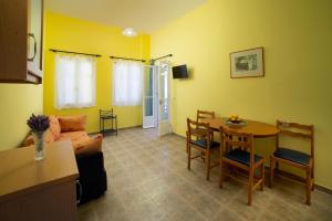 a living room with a couch and a table at Spertos Apartments in Órmos