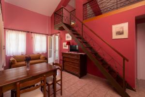 a living room with a staircase and a dining room at Spertos Apartments in Órmos
