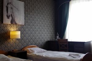 a bedroom with two beds and a window at Villand Hotel with Free Private Parking and Self Check In in Riga