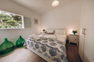 a bedroom with a bed and a window at Saturo Apartments in Leporano