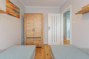 Łóżko lub łóżka w pokoju w obiekcie Apartament Doro