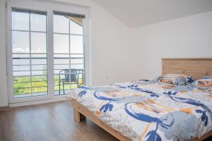 - une chambre avec un lit et une grande fenêtre dans l'établissement Villa Grkasha, à Ohrid