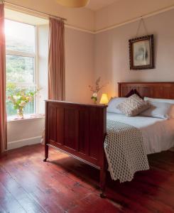 a bedroom with a bed and a window at The Old Monastery Guesthouse in Cahersiveen