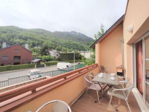 a balcony with a table and chairs and a view at Appartement Saint-Lary-Soulan, 4 pièces, 8 personnes - FR-1-457-182 in Saint-Lary-Soulan