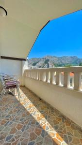 a balcony with chairs and a view of the mountains at Apartments Neven in Omiš +43 photos