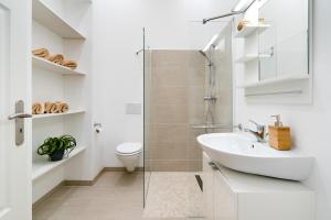 a white bathroom with a sink and a toilet at GreatStay - Lohmeyerstr. 13 VH rechts in Berlin