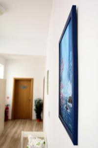 a flat screen tv hanging on a wall at Gile Guest House in Veliko Tŭrnovo