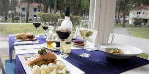 a table with a bottle of wine and a plate of food at Green Park in Punta del Este