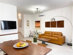 a living room with a table and a couch at Casa Le Volte by Ferrocino Holiday in Nardò