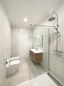 a bathroom with a shower and a toilet and a sink at Casa Le Volte by Ferrocino Holiday in Nardò +16 photos
