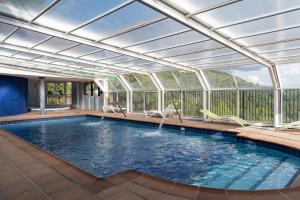 an indoor swimming pool with a glass ceiling at Casas Rurales VegaSierra in Bogarra