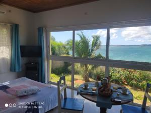 a room with a table and a view of the ocean at Villa bel azur in Diego Suarez