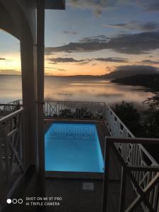 a swimming pool on a balcony with a view of the ocean at Villa bel azur in Antsiranana