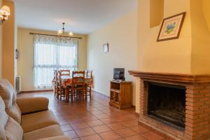 a living room with a fireplace and a dining room at Casas Rurales VegaSierra in Bogarra