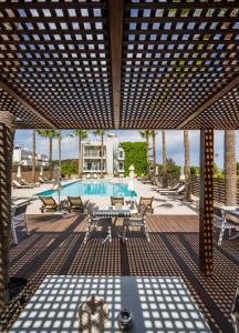 un patio con piscina, tavoli e sedie di Sea View Hotel & Apartments a Kato Daratso