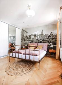 Apartmán Masaryk في تشيسكي كروملوف: غرفة نوم بسرير مع لوحة على الحائط