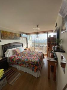 a bedroom with a bed and a view of a balcony at Descanso y Tranquilidad in Santiago