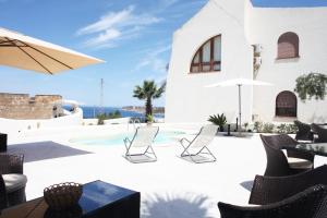 a villa with a swimming pool with chairs and a table at Country Villa San Vito Bay in San Vito lo Capo