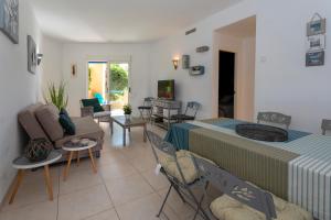 a room with a bed and a living room at Las Dunas, bajo, 2 dormitorios, 25m del mar, by Bookindenia in Denia