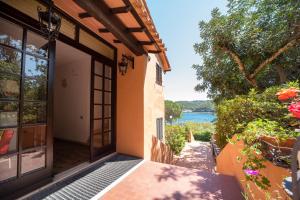 a door to a house with a view of the water at Appartamento Laura in Porto Azzurro