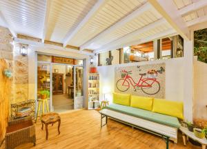 a living room with a bench and a painting of a bike at DuruPduru Kaş in Kaş