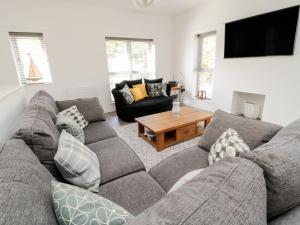a living room with a couch and a table at High Tide House in Craster