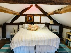 a bedroom with a bed with a dog laying on it at The Cottage, Winley Farm in Bromyard