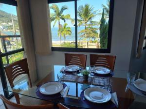 a dining room with a table with a view of the ocean at Lindo apartamento com vista para o mar em Caraguá! in Caraguatatuba