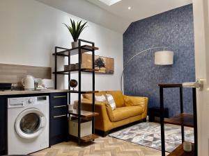 ein Wohnzimmer mit einem Sofa und einer Waschmaschine in der Unterkunft The Gallery At Warrenfield House in Kirkwall
