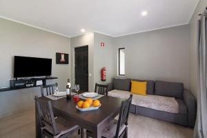 a living room with a table and a couch at Alvor Quinta Nova in Alvor