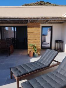 a patio with two couches on a building at Luz del Cabo in El Pozo de los Frailes