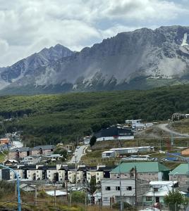 a small town in front of a mountain at USHUAIA CALMA Luxury in Ushuaia