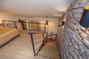 a staircase in a room with a brick wall at La Costa Apartments in Bar