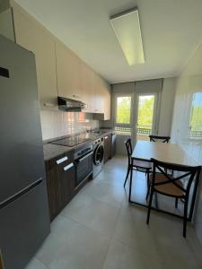 a kitchen with a table and a table and a dining room at Apartamento Turistico Mirador de Valdellera I in Posada de Llanes
