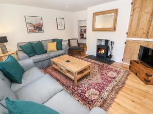 a living room with a couch and a coffee table at Widgeons Keel in Falmouth