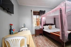 Postel nebo postele na pokoji v ubytování Jinja Grand Hotel