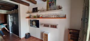 a room with a wall with shelves and glasses on it at Apartamento Callentum (Cazalla de la Sierra) in Cazalla de la Sierra
