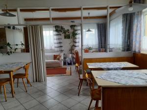 a room with tables and chairs and a living room at Finihaus in Bad Zell