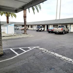 a parking lot with cars parked in front of a building at Economy inn in Corning +3 photos